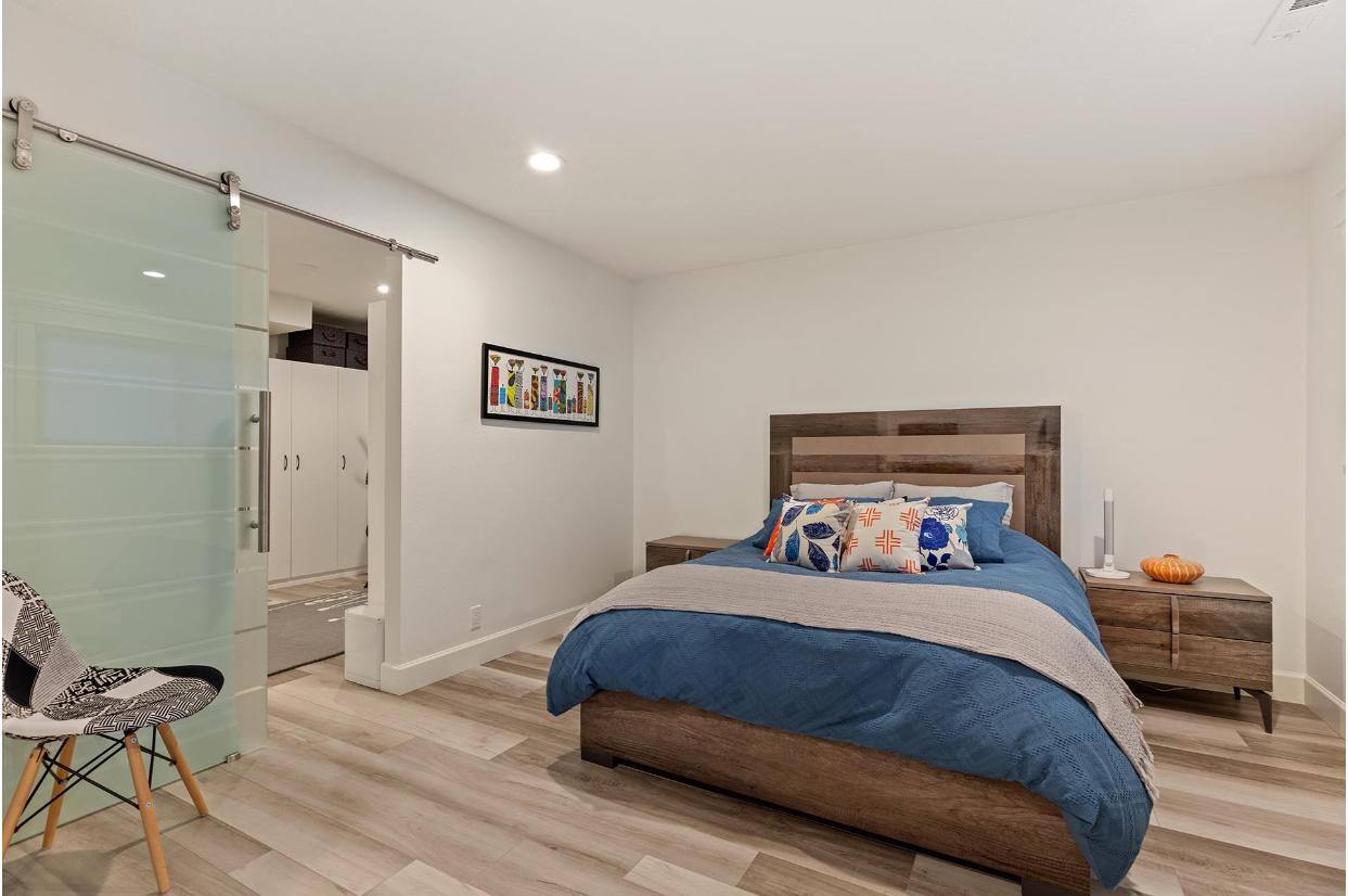 Remodeled Bedroom with Sliding Barn Door by Creekstone Design + Remodel