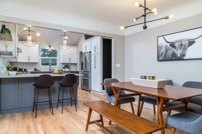 Remodeled kitchen with bar stools and dining area by Creekstone Design + Remodel in Portland, OR