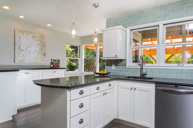 Modern-Kitchen-with-Bubble-Glass-Pendant-Lights-Herringbone-Accent-tile-Counter-to-Ceiling-Teal-Subway-Tile-Backsplash-Black-Counters-Side-Bar-White-C-2