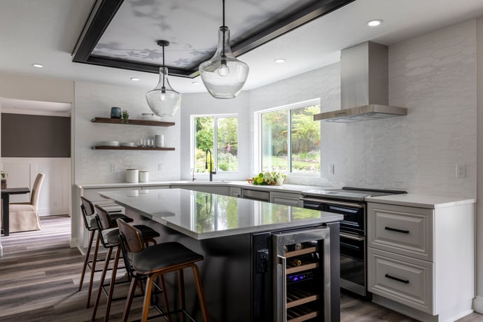 Modern remodeled kitchen with white backsplash, island, barstools and wine fridge