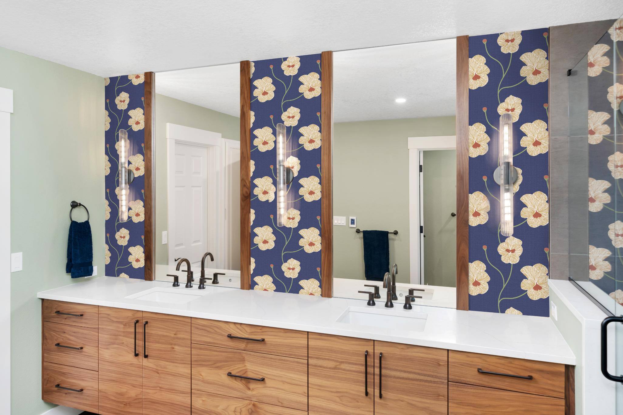 Remodeled bathroom featuring light wood, floral wallpaper, and light walls in Forest Grove, OR by Creekstone Design + Remodel