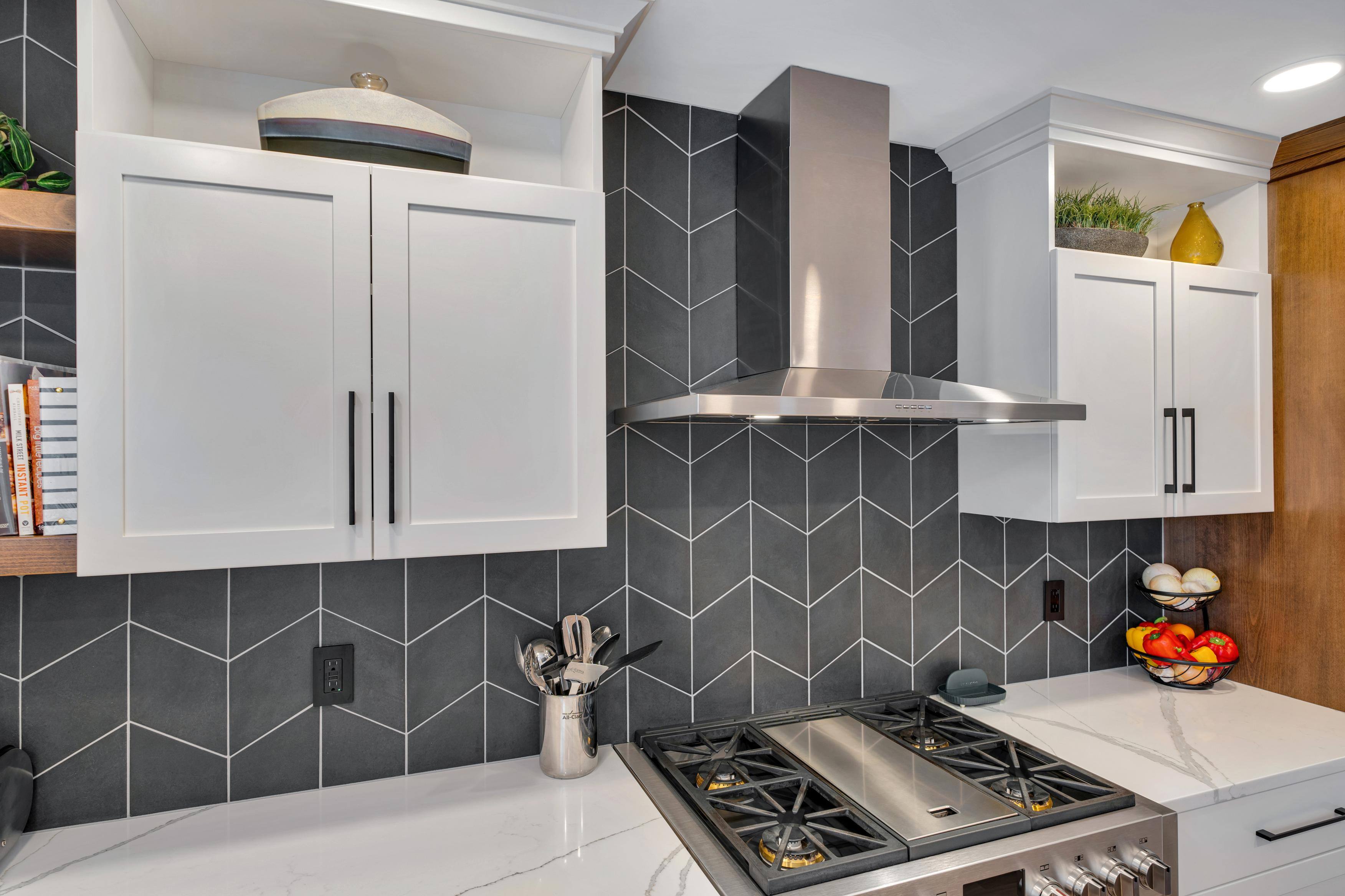 Southwest Hills Kitchen stovetop, range, and gray backsplash by Creekstone Design + Remodel