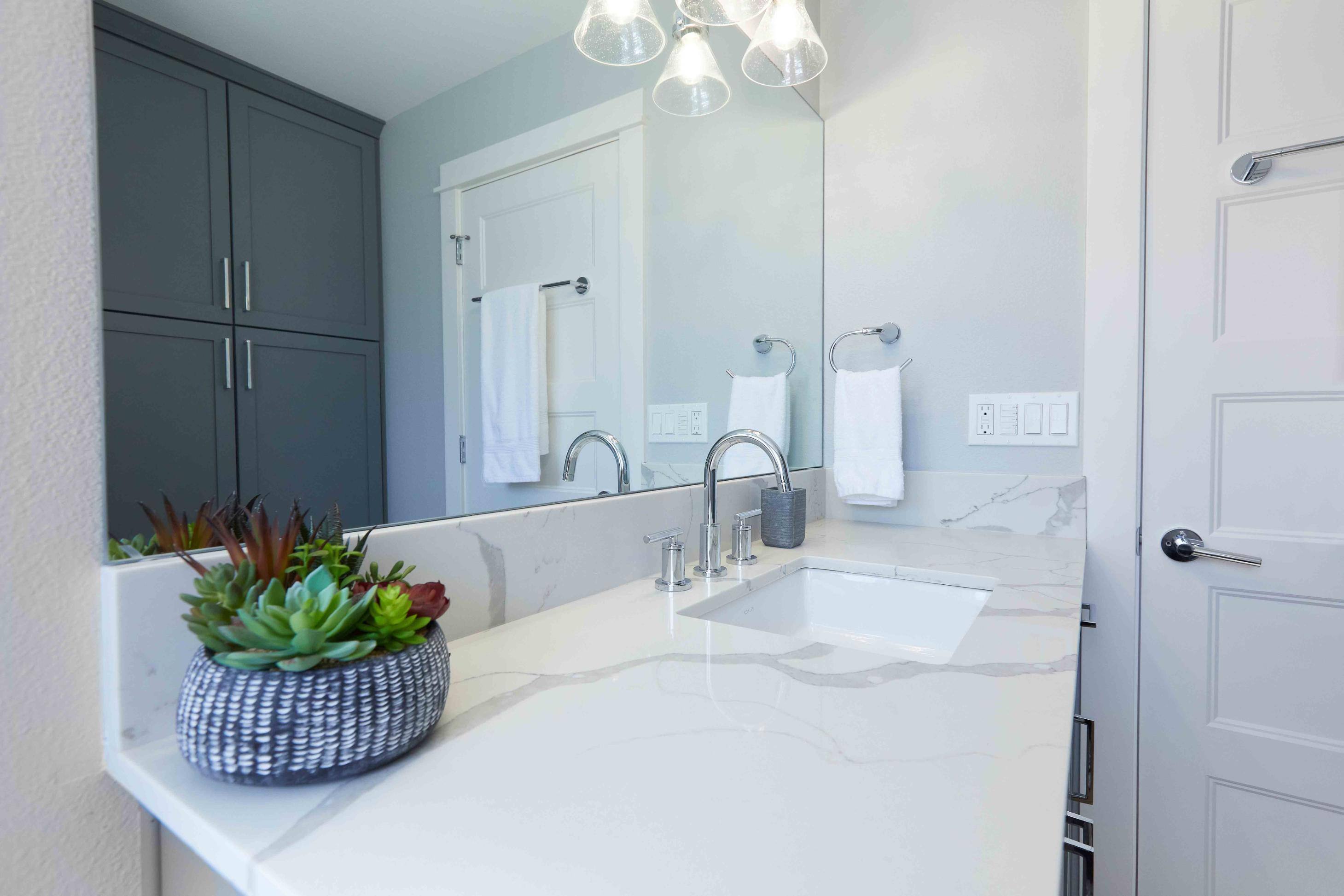 Remodeled bathroom vanity with view of storage closet in Tigard, OR by Creekstone Design + Remodel