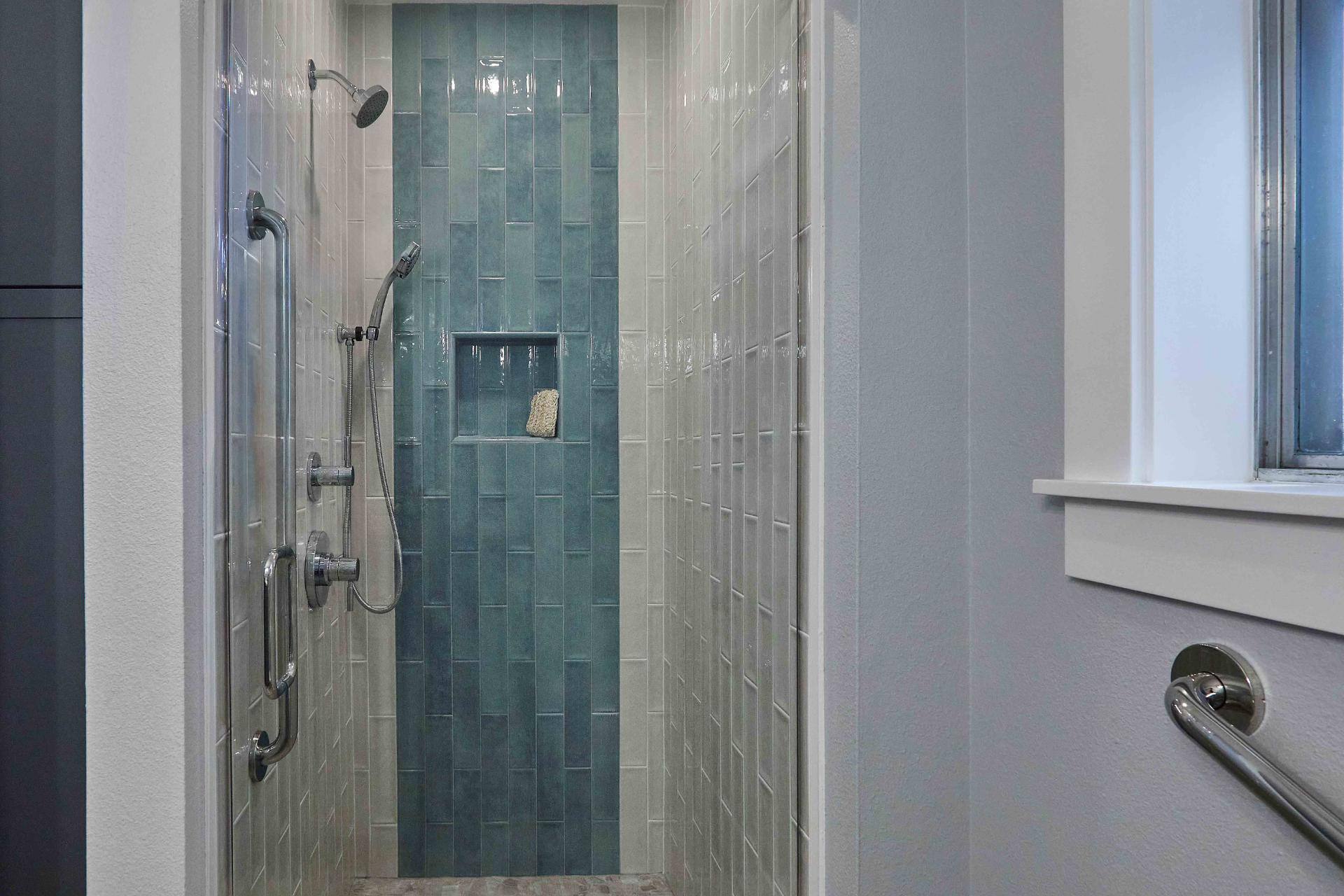 Remodeled bathroom walk-in shower with blue and white tile in Tigard, OR by Creekstone Design + Remodel