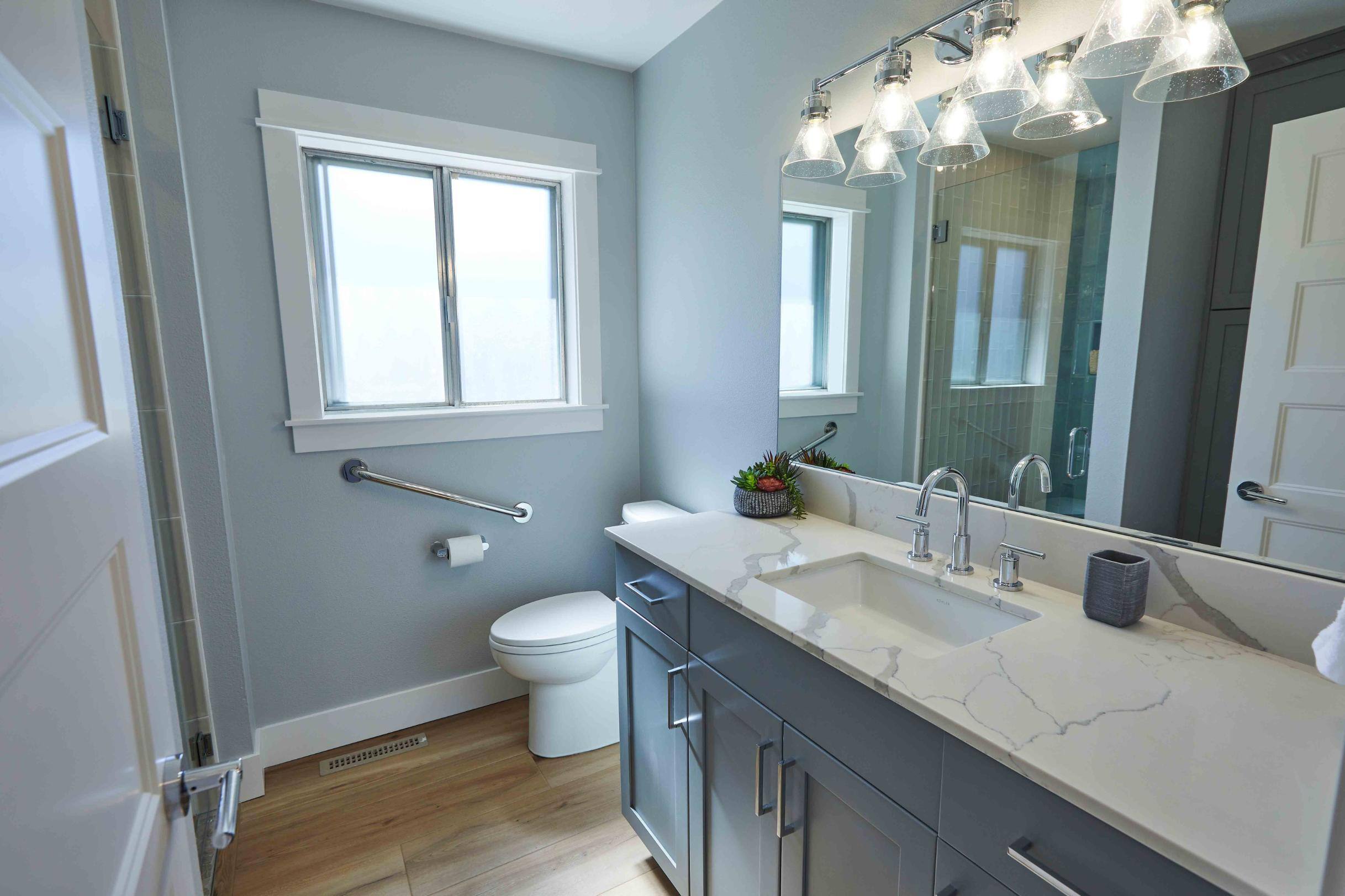 Remodeled hall bathroom with walk-in shower in Tigard, OR by Creekstone Design + Remodel