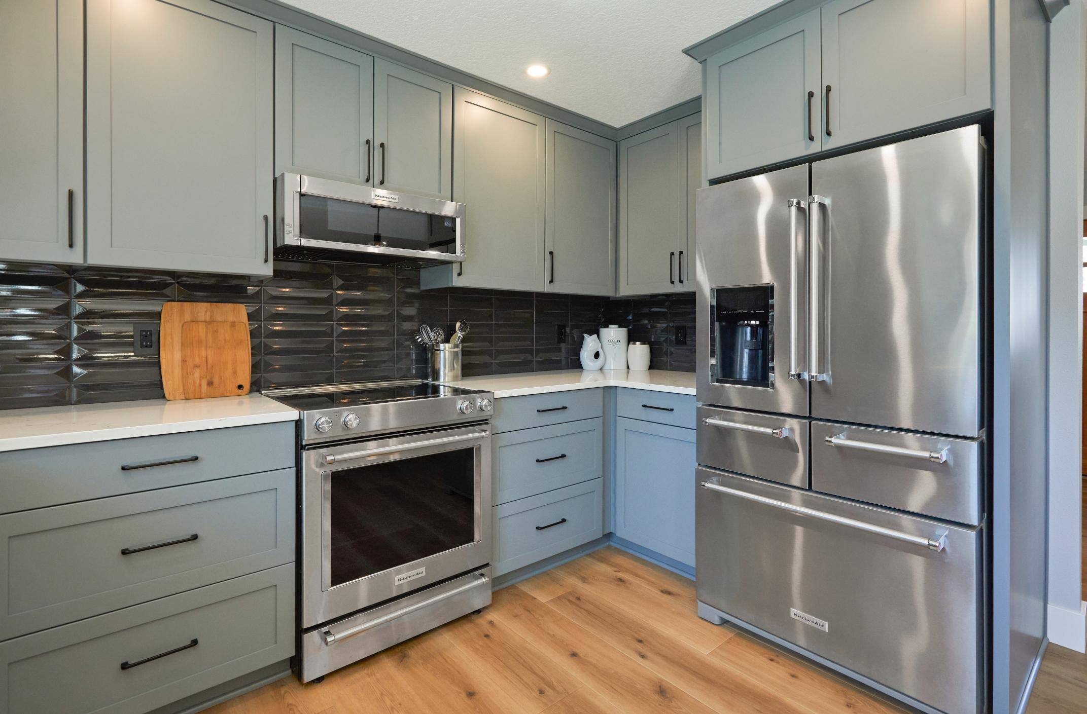 Remodeled kitchen stainless steel appliances and gray cabinetry in Tigard, OR by Creekstone Design + Remodel