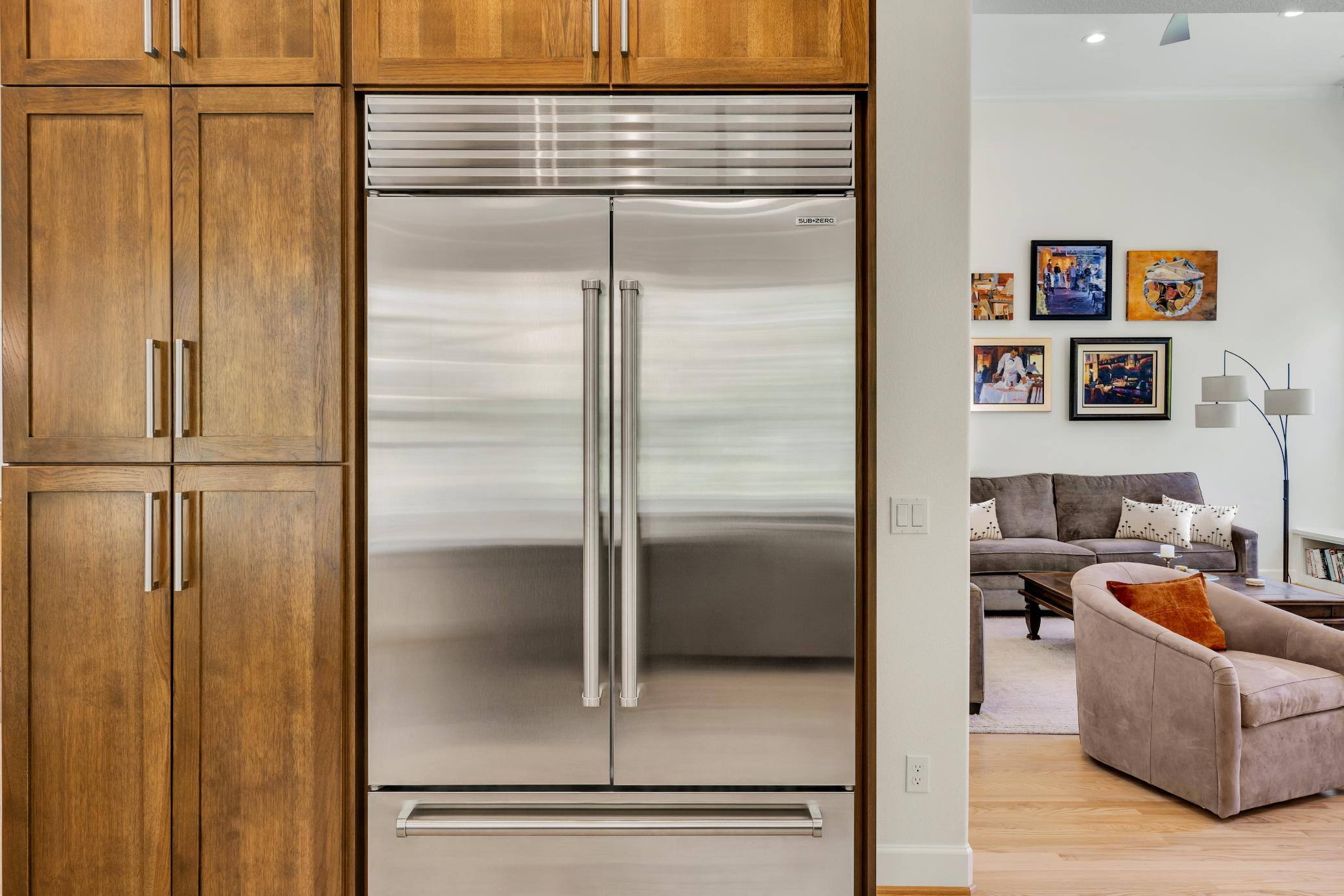 West-Sylvan Kitchen Remodel refridgerator and surrounding wooden cabinetry by Creekstone Design + Remodel